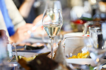 Glassware, glasses for white wine on a table in the restaurant. Banquet, cutlery, table setting. 