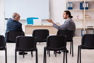 Two businessmen in the classroom in pandemic concept