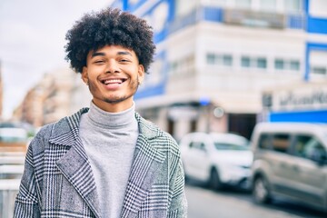 Young african american businessman smiling happy standing at the city.