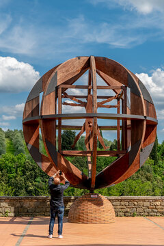 A man photographs the Vinci man in the historic center of Vinci, Florence, Italy