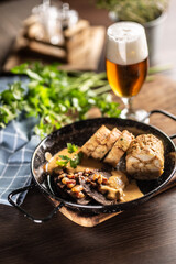 Typical Czech food svickova na smetane with dumplings and a draft pilsener beer in a glass