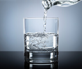 Pouring soda in glass. glass with water and air water bubbles  or soda floating up to water...