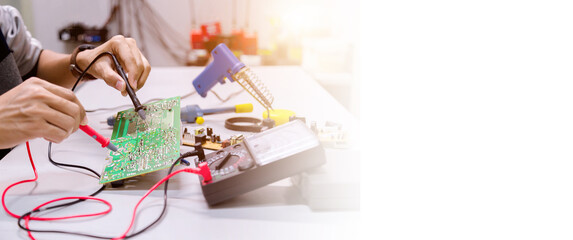 Close up of the hand men hold tool repairs electronics manufacturing Services,Repair of electronic devices, tin soldering parts.