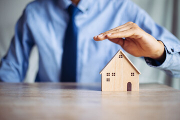 Insurance house, and family health live concept. The insurance agent presents  the ้hands...