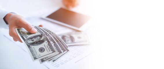 Fototapeta premium Businessman with money in hand, US dollar,investment, success and profitable business concepts.