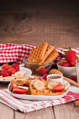 Waffles with strawberries, bananas and honey.