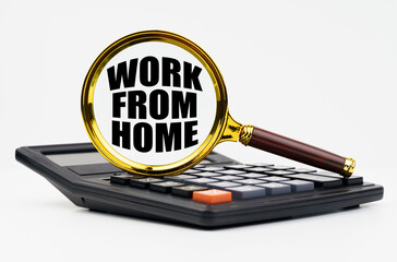 On a white background lies a calculator and a magnifying glass with the inscription - Work from home