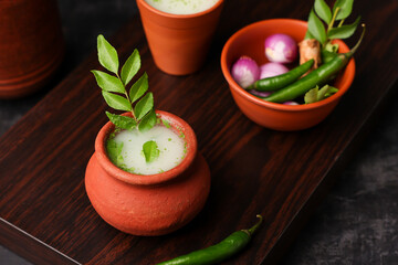 Spiced buttermilk in clay pot , chaas , chaach , moru , sambharam , curd, lassi , yogurt, cool refreshing drink for hot summer in glass , Kerala, India. Flavored Indian buttermilk.	