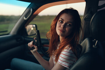 Fototapeta na wymiar woman in car with arms in hand field landscape t-shirt model window