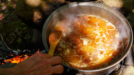 cooking lamb pilaf on a fire