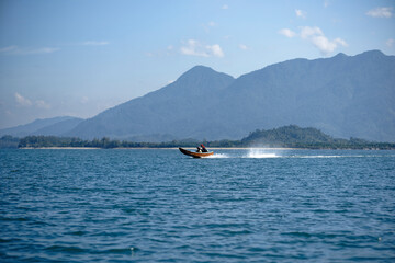 A Scenic view from Remote place in Thailand, Big mountain Landscape with tourist or local boat in Ocean 