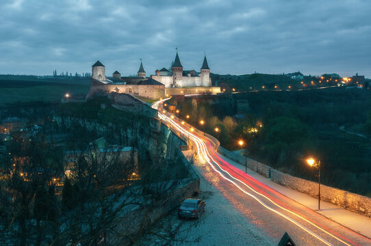 Panoramic night view of the ancient castle fortress. Photo of an ancient castle on a postcard or cover