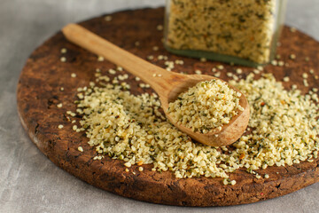 Shelled hemp seeds on a spoon, close up