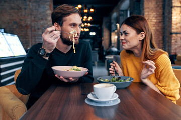 man and woman sitting in cafe dinner emotions fun