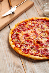 Closeup on hunter's sausage pizza on the wooden rustic table