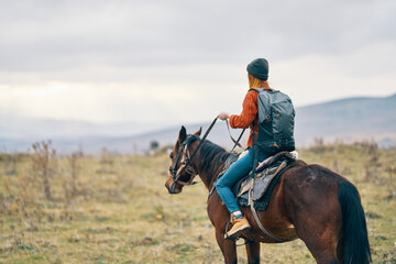 woman hiker riding horse travel mountains landscape