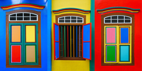 Multicolored wall with three different colorful windows and sashes. Optimistic bright colors 
