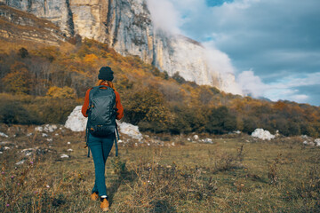 Fototapeta premium traveler with backpack rest in the mountains outdoors in autumn landscape blue sky rocks
