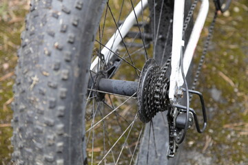 Used white bicycle oiled chain gear with selector on 7-speed cassette cogwheels, hard tail mountain...