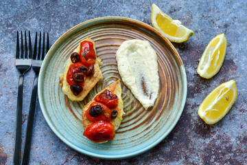 Keto caprese chicken .Grilled chicken with mozzarella cheese,olives  basil and tomatoes with celery puree. Ketogenic diet food