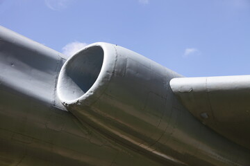 Turbojet engine of a flying Soviet supersonic military aircraft close-up against a clear blue sky, a monument to Russian long-range aviation