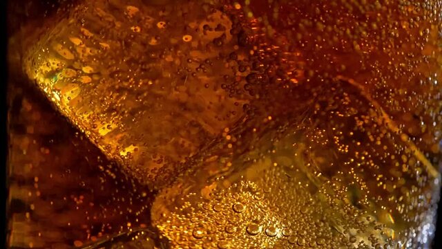 Ice cubes in glass with poured cola x6 slowmo