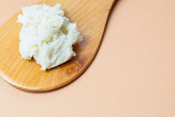 Shea butter on wooden spoon, beautiful, simple composition, unrefined, close up