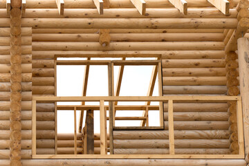 Front view of wooden house. Building a cottage from a round log.