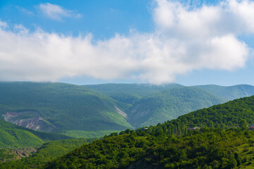 Clouds over green mountains landscape