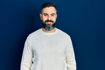 Fototapeta premium Young hispanic man wearing casual clothes with a happy and cool smile on face. lucky person.