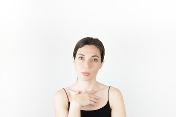 Young beautiful woman pointing up with fingers while thinking at white empty background