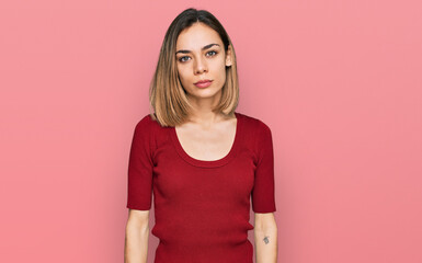 Obraz premium Young blonde girl wearing casual clothes relaxed with serious expression on face. simple and natural looking at the camera.