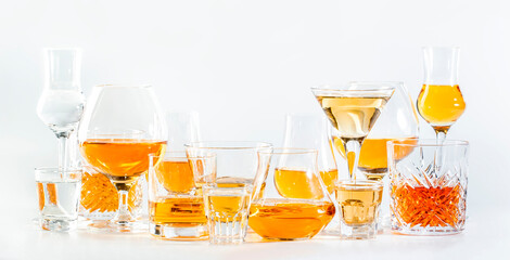 Hard strong alcoholic drinks, spirits and distillates in glasses in assortment: vodka, cognac,...