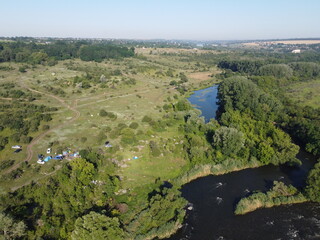 Winding bed of the Southern Bug river. River, landscape from a bird's eye view. Rough, rocky terrain.