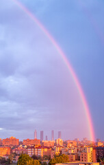 Fototapeta na wymiar rainbow at sunrise over the skyline of the city of Madrid