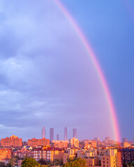 rainbow at sunrise over the skyline of the city of Madrid