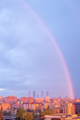 rainbow at sunrise over the skyline of the city of Madrid