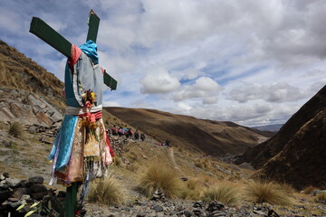 Holy cross from the peregrination in cusco peru, honoring to the señor de qoyllur rit'i, inka ceremony and procession nearby a glacier in south america, pilgrimage activity in beautiful nature - obrazy, fototapety, plakaty