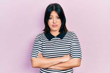 Obraz premium Young hispanic woman with arms crossed gesture skeptic and nervous, frowning upset because of problem. negative person.