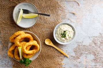 Fresh homemade calamari with homemade tartar sauce and lemon.