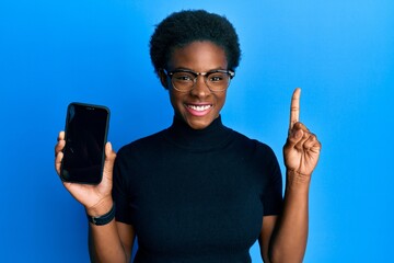 Young african american girl holding 5g technology smartphone smiling with an idea or question...
