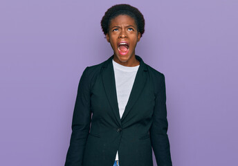 Young african american girl wearing business clothes angry and mad screaming frustrated and furious, shouting with anger. rage and aggressive concept.