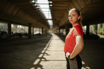 Young female athlete looking away. Motivated and focused sporty woman before a run.