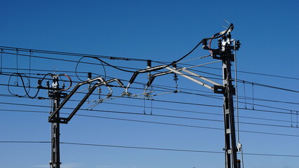 electric train catenary against sky
