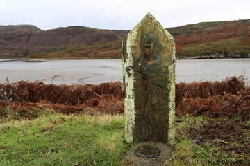 An old survey marker stone near Penrhyndeudraeth, Gwynedd, Wales, UK.