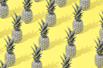 Creative summer pattern background with gray pineapple on a yellow background. Minimal style. Creative summer or food concept.