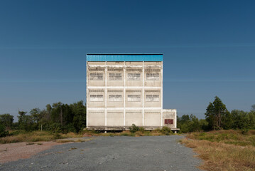 Fototapeta na wymiar Abandoned Mysterious Building apart on sultry land