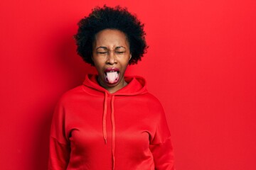 Fototapeta na wymiar Young african american woman wearing casual sweatshirt sticking tongue out happy with funny expression. emotion concept.