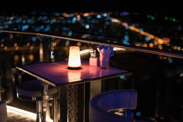 Rooftop table of pub and restaurant with cityscape view