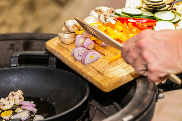 Fototapeta na wymiar Chef prepares fresh vegetables on the grill. Close up